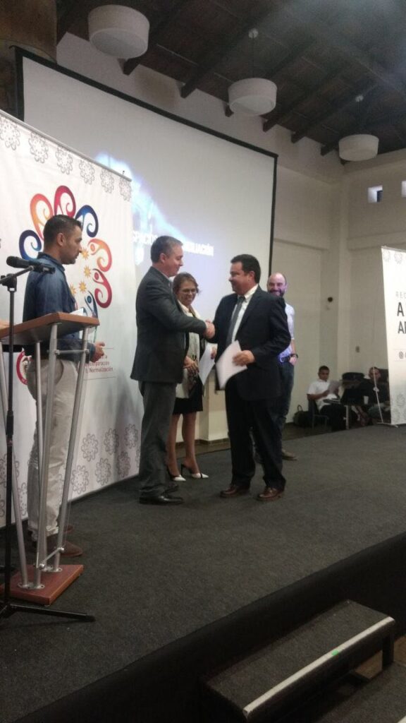 Alvaro Daza receiving recognition from the ARN